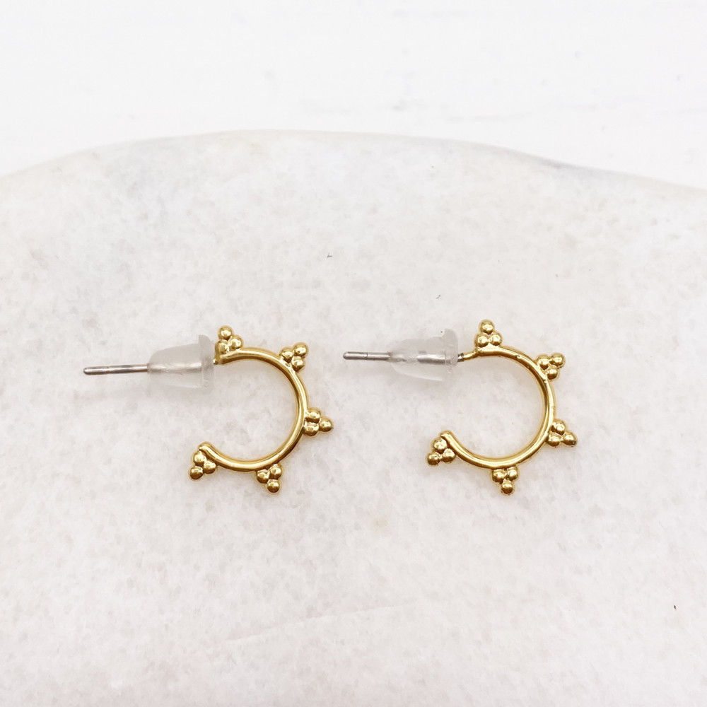 Small golden hoops adorned with small dots